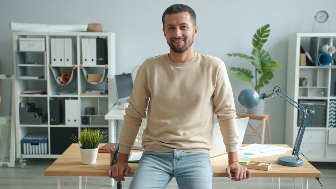 A focused entrepreneur working at a co-working desk in a modern London flexible workspace