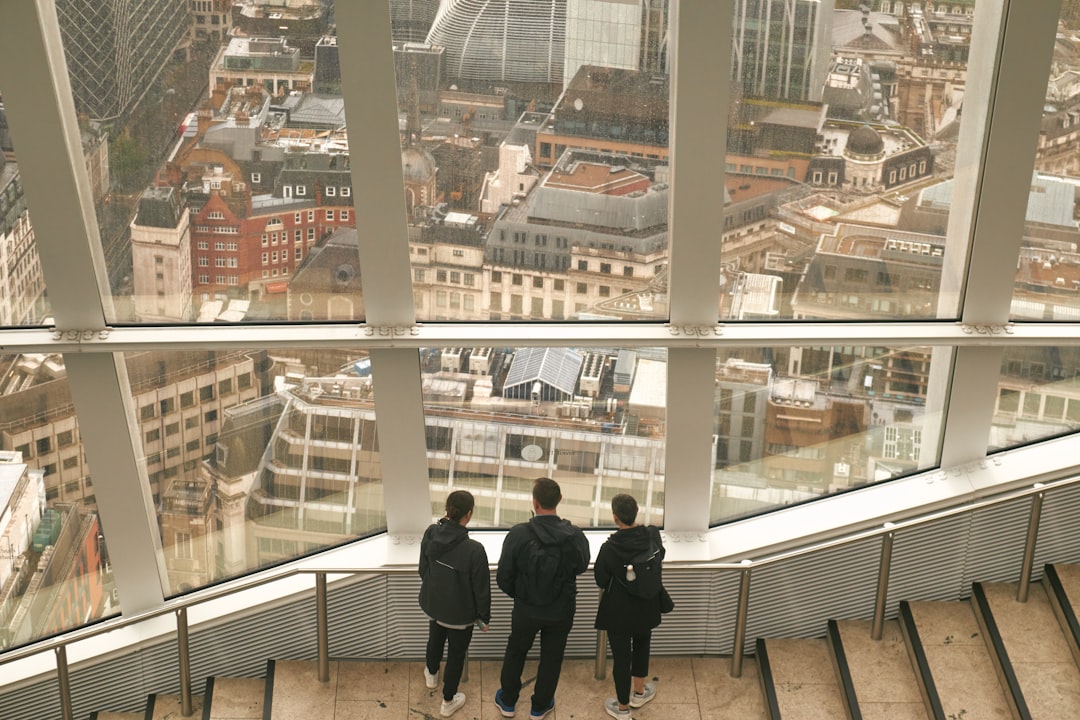 A couple visiting a residential property with an estate agent, discussing the space during a buy-to-let flat viewing in Londo