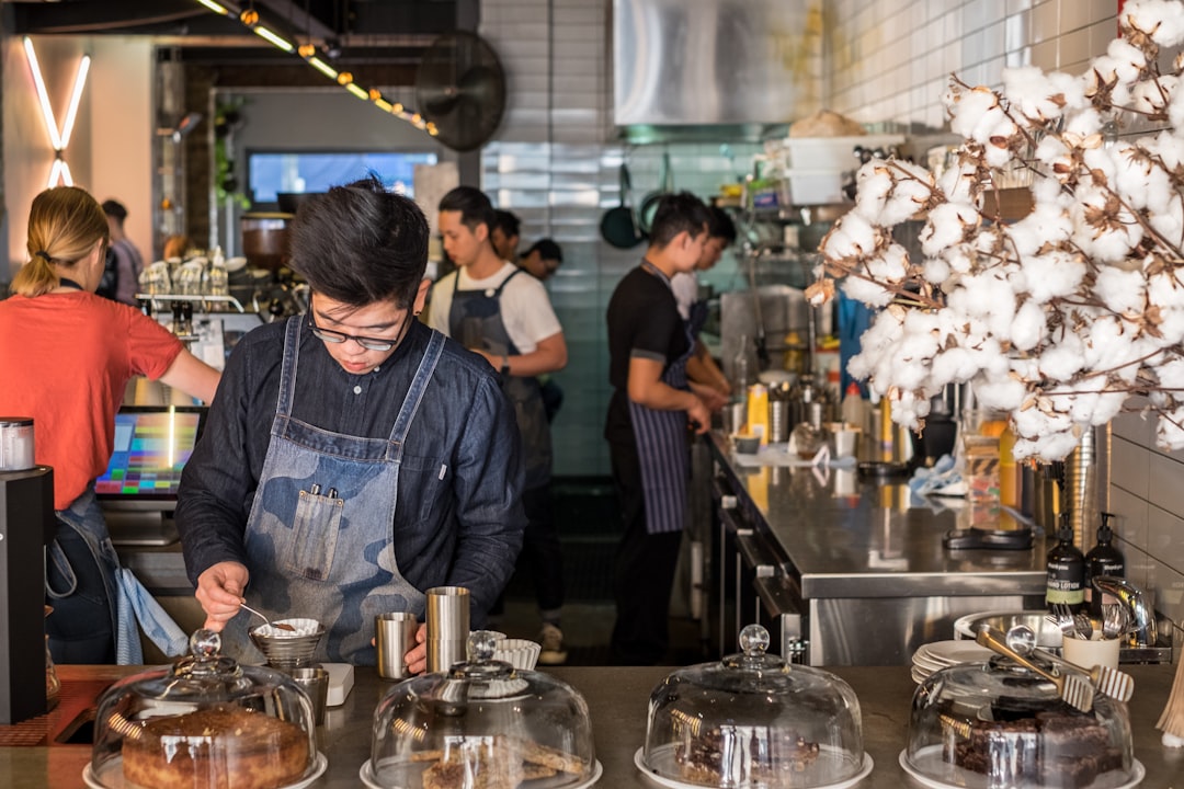 A barista crafts latte art at one of London's best independent coffee roasters, showcasing the specialty in every cup.