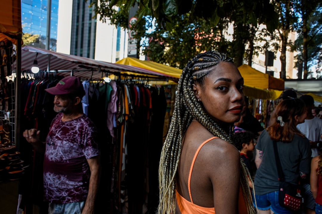 A Ghanaian community market trader in London arranges traditional fabric and food at an outdoor stall