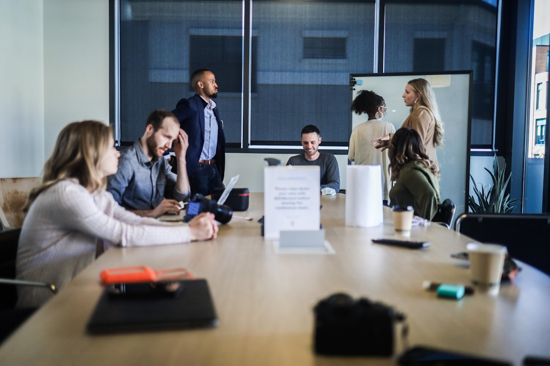 An early-stage founder presents her business plan to investors inside a City of fintech accelerators programme boardroom.