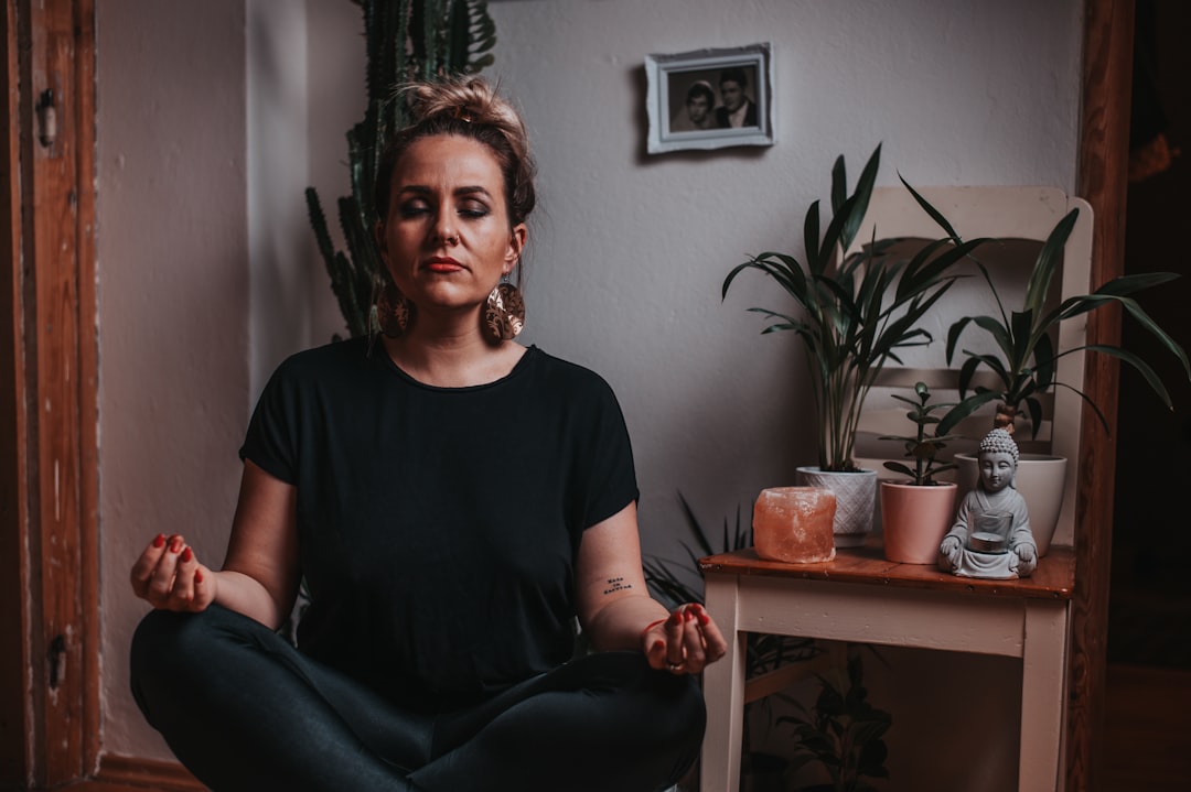 A woman practising conscious breathing in one of London's leading breathwork studios, lying on a mat in a softly lit room.