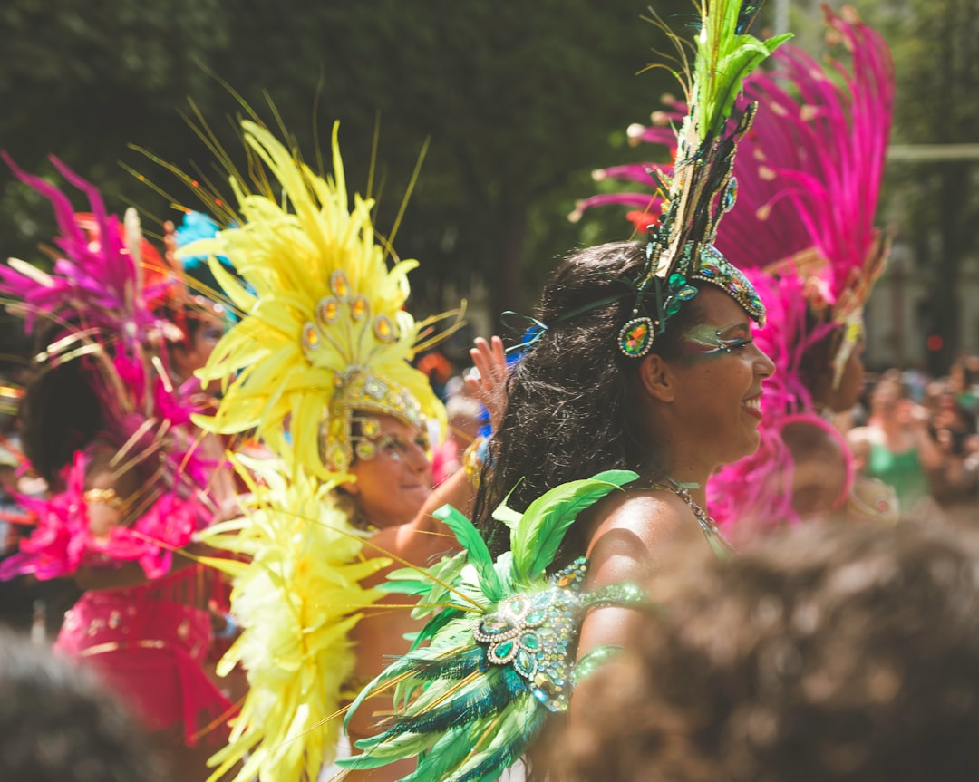 A costumed dancer performing at Notting Hill Carnival in front of crowds on Ladbroke Grove