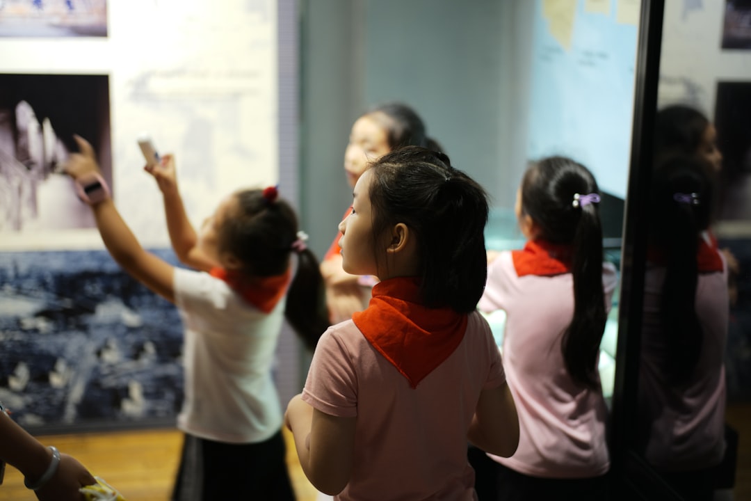 A young girl reaches out to touch a dinosaur fossil display inside one of London's top children's museums