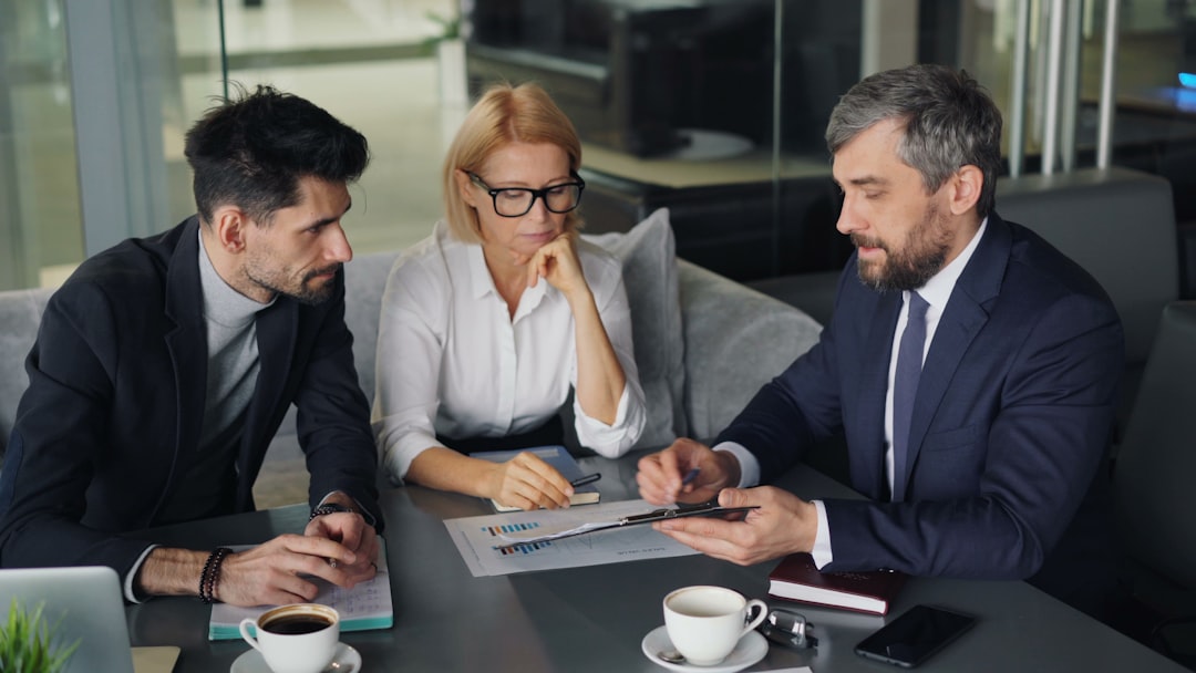 A financial advisor in a London office explains how to open a stocks ISA to a client across the desk