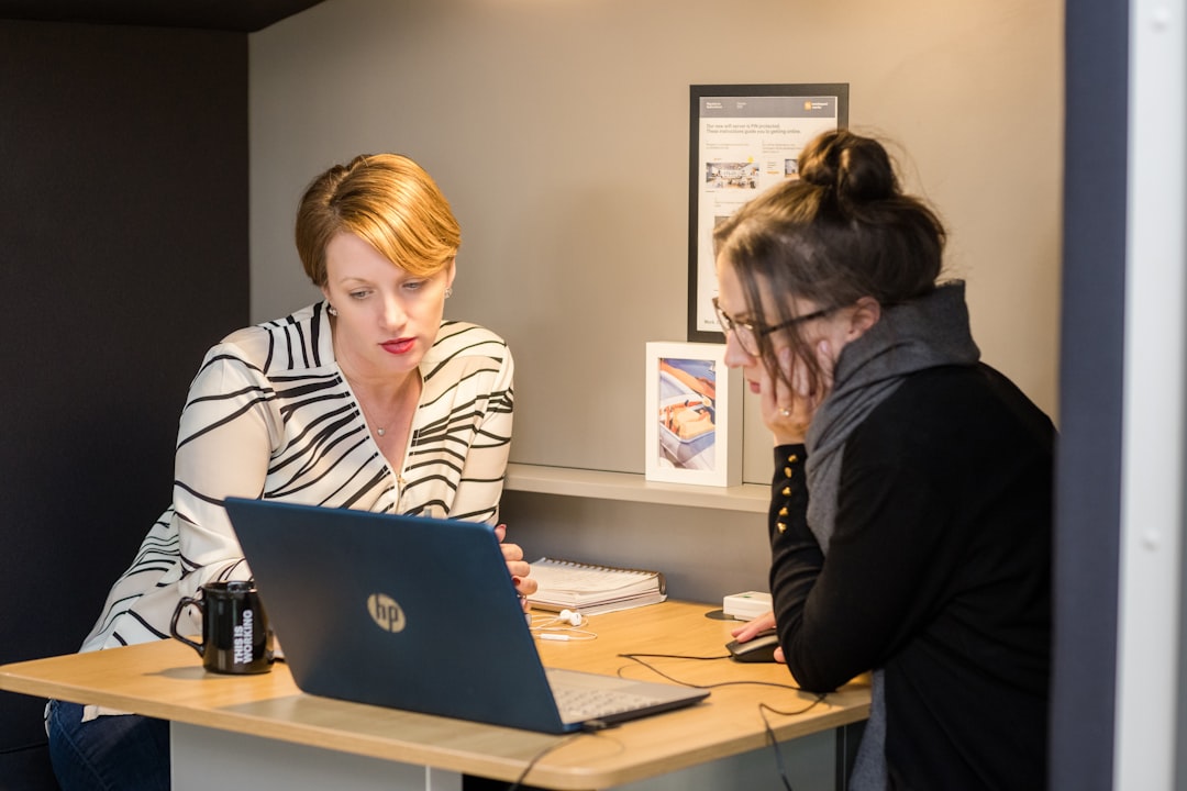 A London finance director conducts a business audit at her office desk in the City, reviewing financial records before Q4.