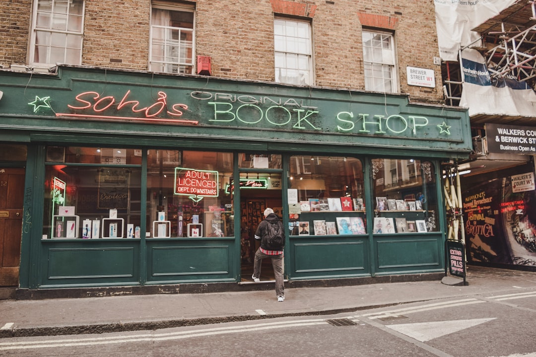 A woman carefully browses shelves inside one of London's independent bookshops on a summer afternoon