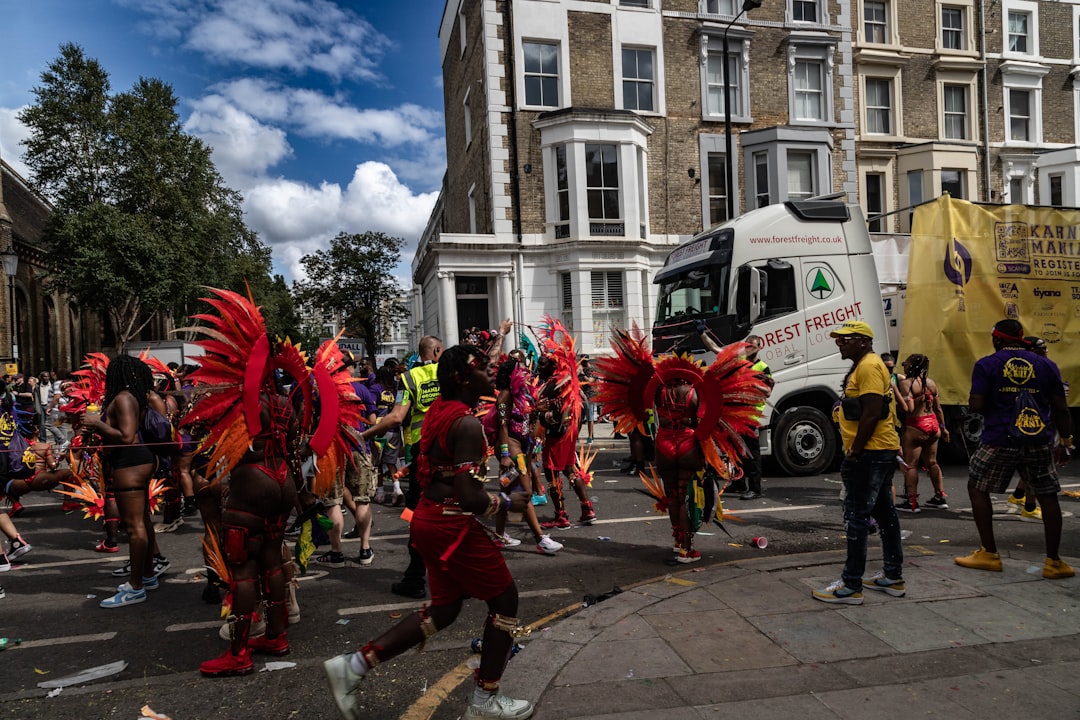 A woman in a colourful costume dancing at the Notting Hill Carnival during the bank holiday weekend in London