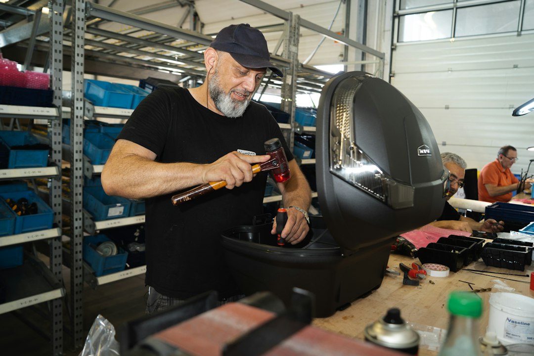 Volunteer fixer at a London repair cafes session mending a small appliance